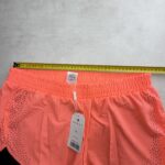 Moraj short running 2-en-1 corail perforé XL neuf